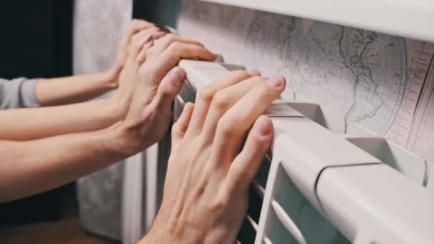 Frozen Male Female Hands Touch Home Radiator Try Warm Home — Stockvideo
