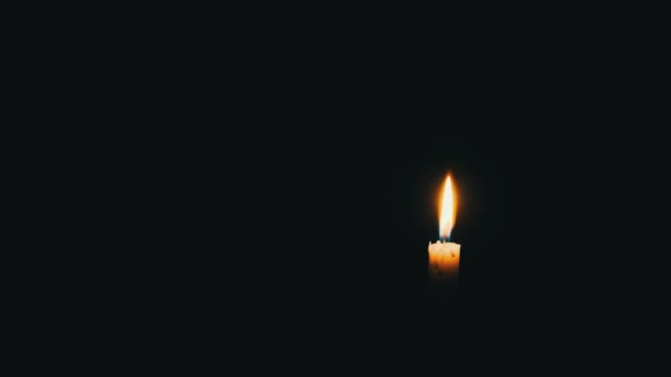 One Candle Lit Black Background Close Yellow Flickering Flame Illuminates — Video