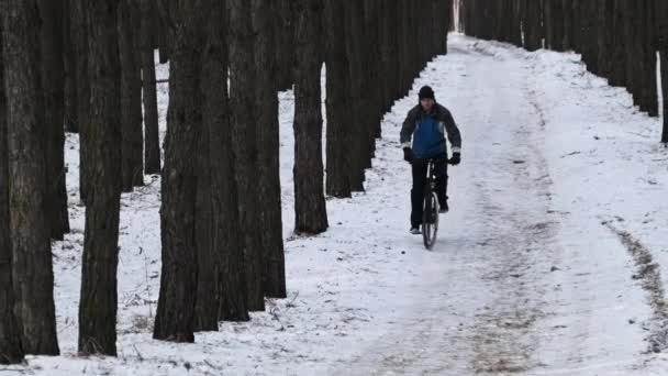 Man Ride Bicycle Snowy Path Winter Trees Slow Motion Young — Stockvideo