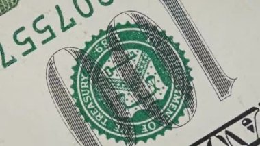 100 US banknote spinning in extreme macro. Fragment of one hundred dollar bill rotates close-up. Cash money background. High-resolution view of USD currency. Business, investment, fiat money, finance