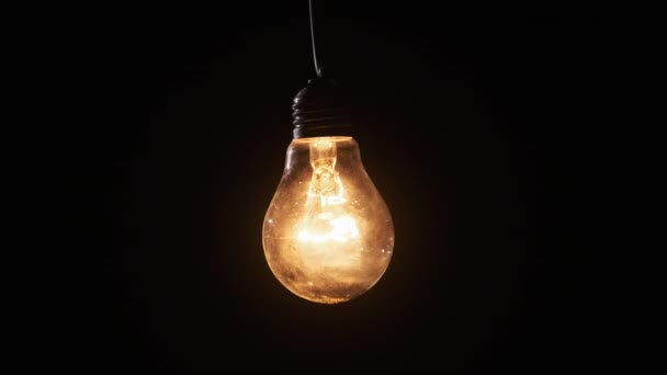 Incandescent Lamp Glows Flickers Black Background Edison Light Bulb Slowly — Stock Video