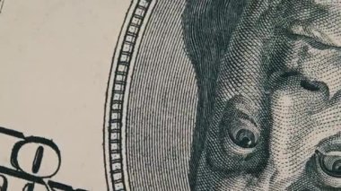 One hundred dollar banknote rotate in extreme macro. Rotating 100 us bill with Benjamin Franklin portrait. Cash money background. High-resolution view of USD currency cash. Business, investment