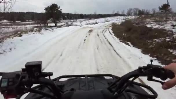 First Person View Man Riding Quad Bike Snowy Terrain Steering — Stock video