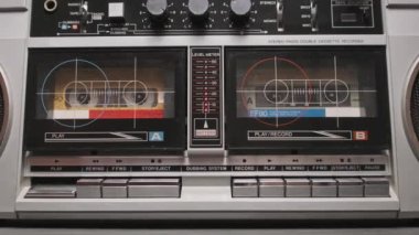 Klasik bir teypten müzik. Eski bir ses kasedinin analog sesi. Masadaki iki kaset çalar üzerindeki erkek el ile oynatma düğmesine bas ve müzik dinle. 80 'lerden kalma bir teyp kaydı.