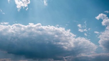 Yumuşak beyaz kümülüs bulutları mavi gökyüzünde yavaşça hareket eder, zaman kavramı. Işık sakin bulutların arka planı bulutlu uzayda şekil değiştirir. Doğal arka plan, hızlandırılmış zaman, kopyalama alanı. 4K