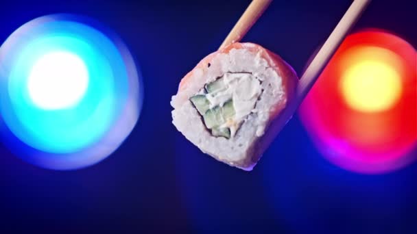 Tome Sostenga Rollo Sushi Usando Palos Sushi Sobre Fondo Colorido — Vídeos de Stock