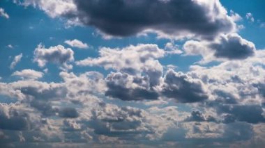 Timelapse of cumulus clouds moving in the blue sky. Cloud space background with dark, light and grey clouds changing shape, time lapse. Change of weather. Nature, sky clouds, copy space