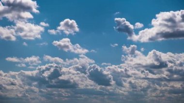Timelapse of cumulus clouds moving in the blue sky. Cloud space background with dark, light and grey clouds changing shape, time lapse. Change of weather. Nature, sky clouds, copy space