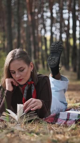 Függőleges Gyönyörű Fiatal Fekszik Egy Takarón Könyvet Olvas Erdőben Keze — Stock videók