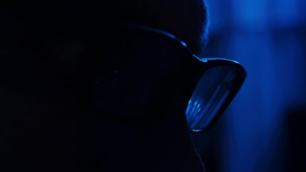 Silhouette Man Glasses Working Computer Dark Blue Room Close Thoughtful — Stock Video