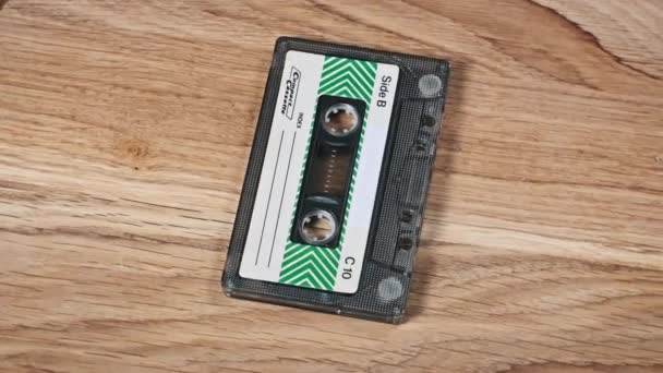 One Audio Cassette Lies Rotates Wooden Table Close Vintage Audiotape — Stock Video