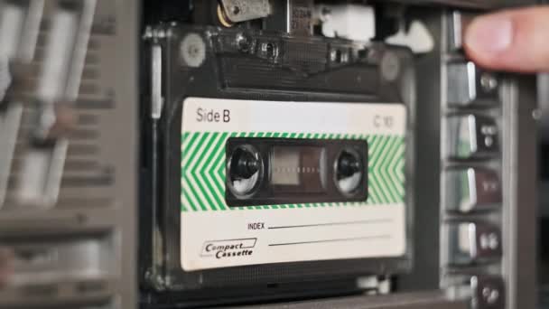 テープレコーダーにオーディオカセットを挿入して再生し 排出し クローズアップします 古いオーディオカセットを再生する レトロプレーヤーのヴィンテージレコードサウンド 再生または再生の会話 デッキで回転するレトロテープリール — ストック動画