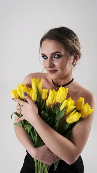Woman Holds Close Her Vivid Bouquet Yellow Tulips White Background — Stock Video