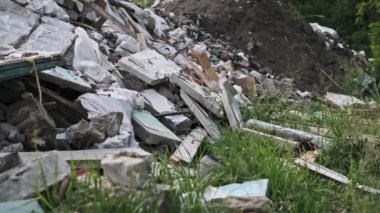 Bu klip, bir ormana atılan büyük bir inşaat enkazı yığınını gösteriyor. Sorumsuz atıkların atılmasının yol açtığı çevresel hasarı vurguluyor. Beton bloklar ve ahşap kalaslar bölgeyi kirletiyor.