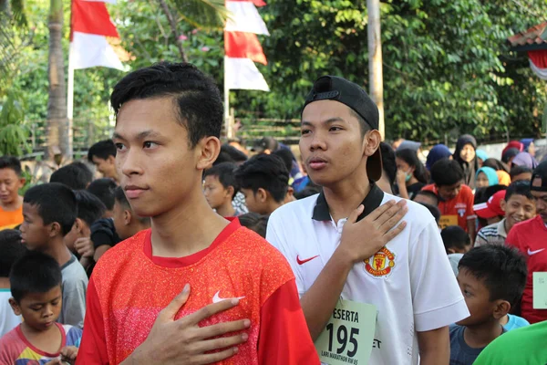 インドネシア ジャカルタ 2018年8月19日 インドネシア第73回独立記念日を祝う村間マラソン大会の開会式でインドネシア国歌を歌う男 — ストック写真