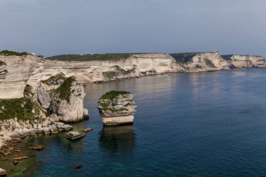 Harbor with yachts, limestone rocks and stone fortress.Sights and Landscapes of Corsica Island