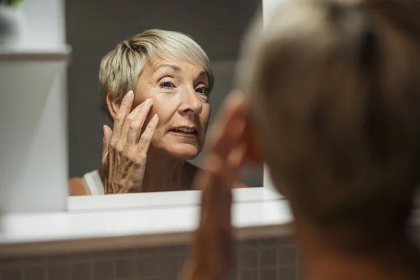 Reife Frau Schaut Ihr Gesicht Badezimmer Sie Untersucht Falten Auf — Stockfoto