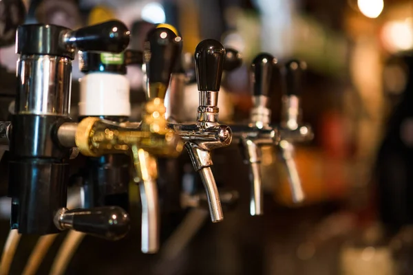 stock image Close up image of beer taps at pub.