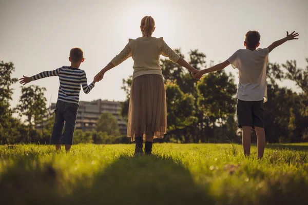 Happy Mother Playing Her Sons Park Holding Hands Enjoying Sunset — Stock Photo, Image