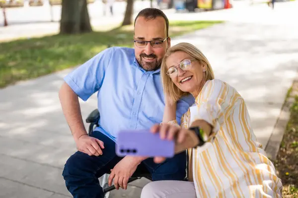 Mannen Rullstol Tillbringar Tid Med Sin Mamma Parken Tar Selfie Stockbild