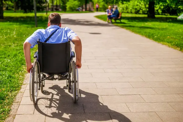 Man Wheelchair Rolling Pathway Park Fotos de stock libres de derechos
