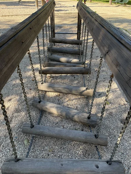 View of a wooden suspension bridge in a park