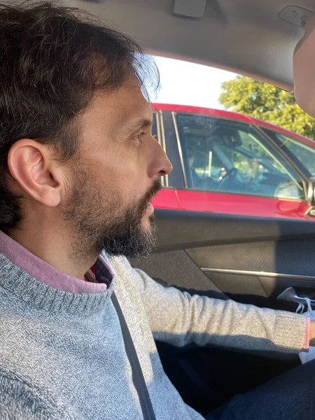 Sad man in the driver's seat of a car in a traffic jam. Transpor