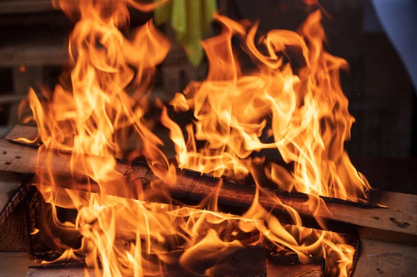 stock image wood fire wiht orange flames in a fire grill