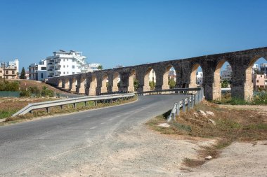 Old Kamares Aqueduct or Bekir Pasha Aqueduct near Larnaca, Cyprus. Scenic view of historical landmark and popular tourist attraction, distinctive arches in Roman style, outdoor travel background
