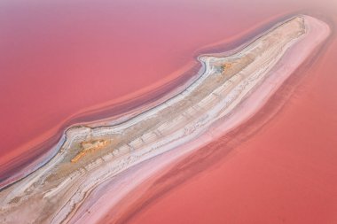 Aerial view of extremely salty lake with salt shelf in the pink water, natural abstract background, famous landmark near Henichesk, Ukraine clipart