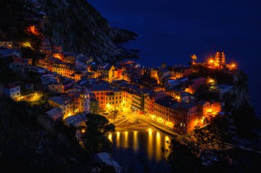 Stunning view of Vernazza village in Cinque Terre National Park, beautiful cityscape with colorful houses, cliffs, sea and a harbor at twilight, Liguria region of Italy. Outdoor travel background