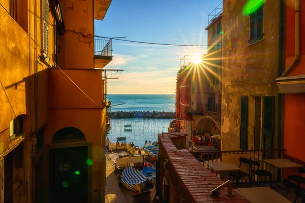 stock image Riomaggiore city view, old village with medieval architecture, colorful houses, sea and fishing boats at sunset, Cinque Terre National Park, Liguria region of Italy. Outdoor travel background