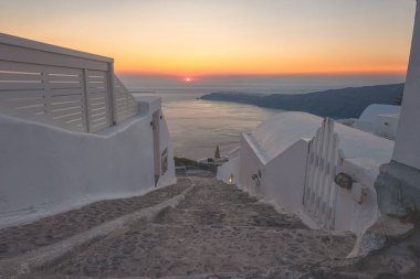 Amazing sunset on Santorini, scenic view of the typical white architecture with caldera view, outdoor travel background, Imerovigli, Santorini island, Greece