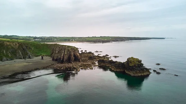 stock image large beach with rock formations from a cliff. Tra na m Beach. Cooper Coast, Waterford, Ireland