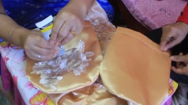 Hand Woman on a Event Dress for Party Manually Fixing a Beads 