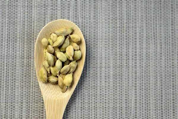 stock image Fresh tasty spices, soft green cardamom or cardamon Top view close up on grey light textured background