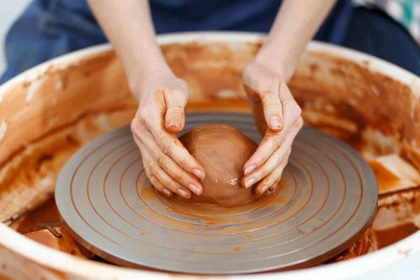 Cropped Image of Unrecognizable Female Ceramics Maker working with clay on Pottery Wheel in Cozy Workshop, Creative People Handcraft Pottery Class.