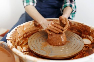 Cropped Image of Unrecognizable Female Ceramics Maker working with Pottery Wheel in Cozy Workshop Makes a Future Vase or Mug,Creative People Handcraft Pottery Class