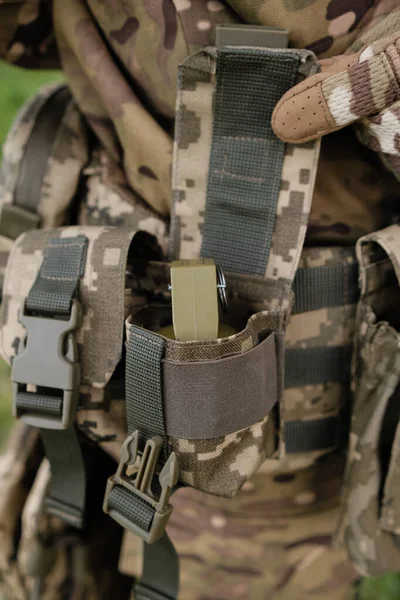 Preparing for Combat: Close-up of Soldier Putting on Gear in the Field
