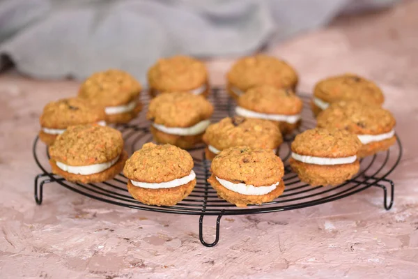 Carrot sandwich cookies with cream cheese frosting
