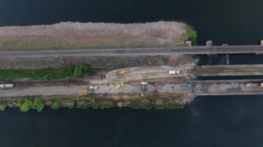 Ukrayna ordusunun Pontoon köprüsü. Yok edilen köprünün yakınına geçici bir geçit kurulmuş. Askerler duba feribotu topluyor. Bir İHA 'dan üst görünüm. 