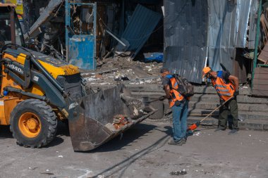 Rus grevinin sonuçları. Dnepr şehrinde, otobüs durağının binasına bir roket çarptı. Kamu hizmetleri çalışanları çarpışmanın sonuçlarını ortadan kaldırıyor. DNIPRO, UKRAINE Ağustos 2023