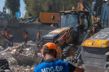 Rus grevinin sonuçları. Dnepr şehrinde, otobüs durağının binasına bir roket çarptı. Kamu hizmetleri çalışanları çarpışmanın sonuçlarını ortadan kaldırıyor. DNIPRO, UKRAINE Ağustos 2023