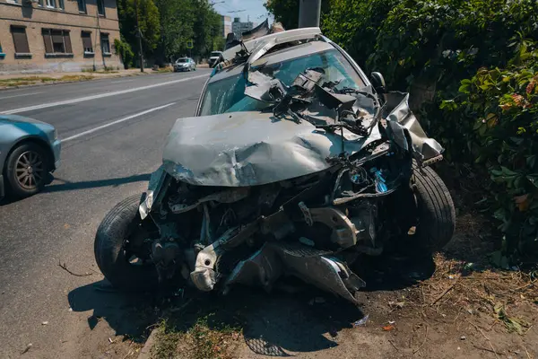 stock image The car crashed into a lamppost. car accident. Close-up. Road accident in the city. Torn off wheel.