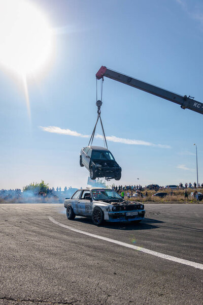 A racing car drifts on a fast track. The driver drifts the car. A car skidding against a background of smoke, smoking wheels. Speed. Extremesport. Route. 