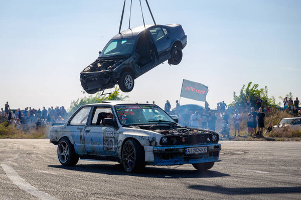 A racing car drifts on a fast track. The driver drifts the car. A car skidding against a background of smoke, smoking wheels. Speed. Extremesport. Route. 