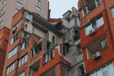 Russian missile hits residential building in Dnipro, Ukraine. Aftermath of enemy attack on city. Destroyed residential multi-story building. Close-up. War. Aftermath of explosion. clipart