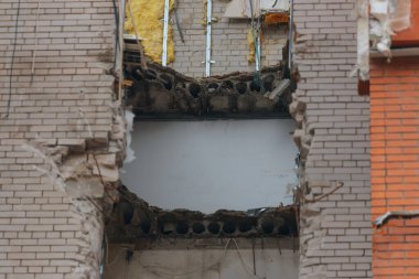 Russian missile hits residential building in Dnipro, Ukraine. Aftermath of enemy attack on city. Destroyed residential multi-story building. Close-up. War. Aftermath of explosion. clipart