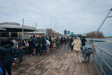 Ukrayna 'da kış tespihi. Epifani banyosu bir halk geleneğidir. Buzlu suya daldırmak. Ortodoks ayini buz deliğinde banyo yapmak. Birçok insan banyo yapar..