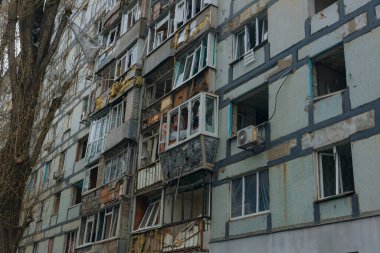 Ukrayna 'da bir konut binasının bombalanmasının sonuçları. Duvarlarda, çatıda ve pencerelerde hasar var. Bir konut binasının yıkımı. Bir yerleşim alanının bombalanması, siviller.